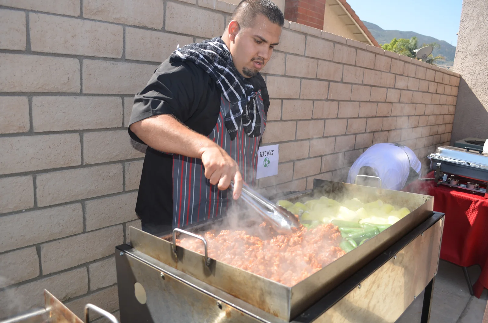 A GoodFellas cook tending an outdoor grill