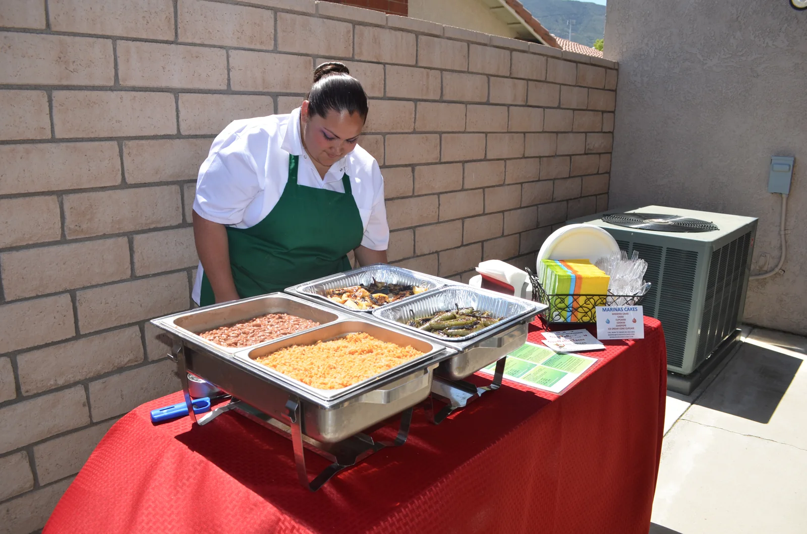 A cook preparing the grill at a backyard event